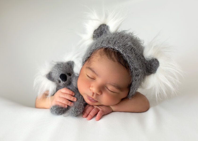 sleeping-infant-peacefully-laying-little-newborn-with-cute-grey-hat-and-toy-bear