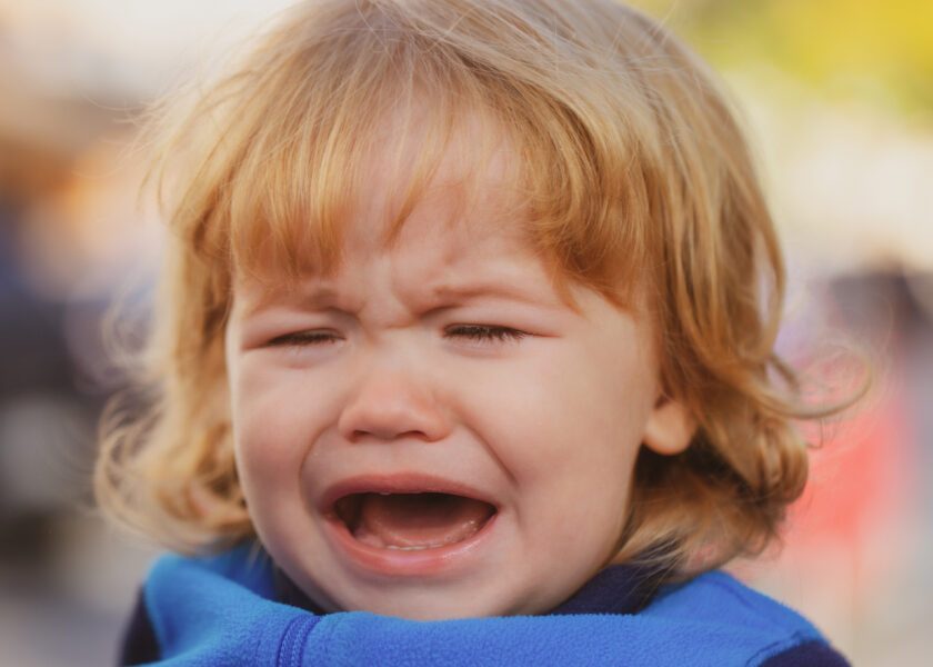 Baby cry. Close up portrait of a crying kid.